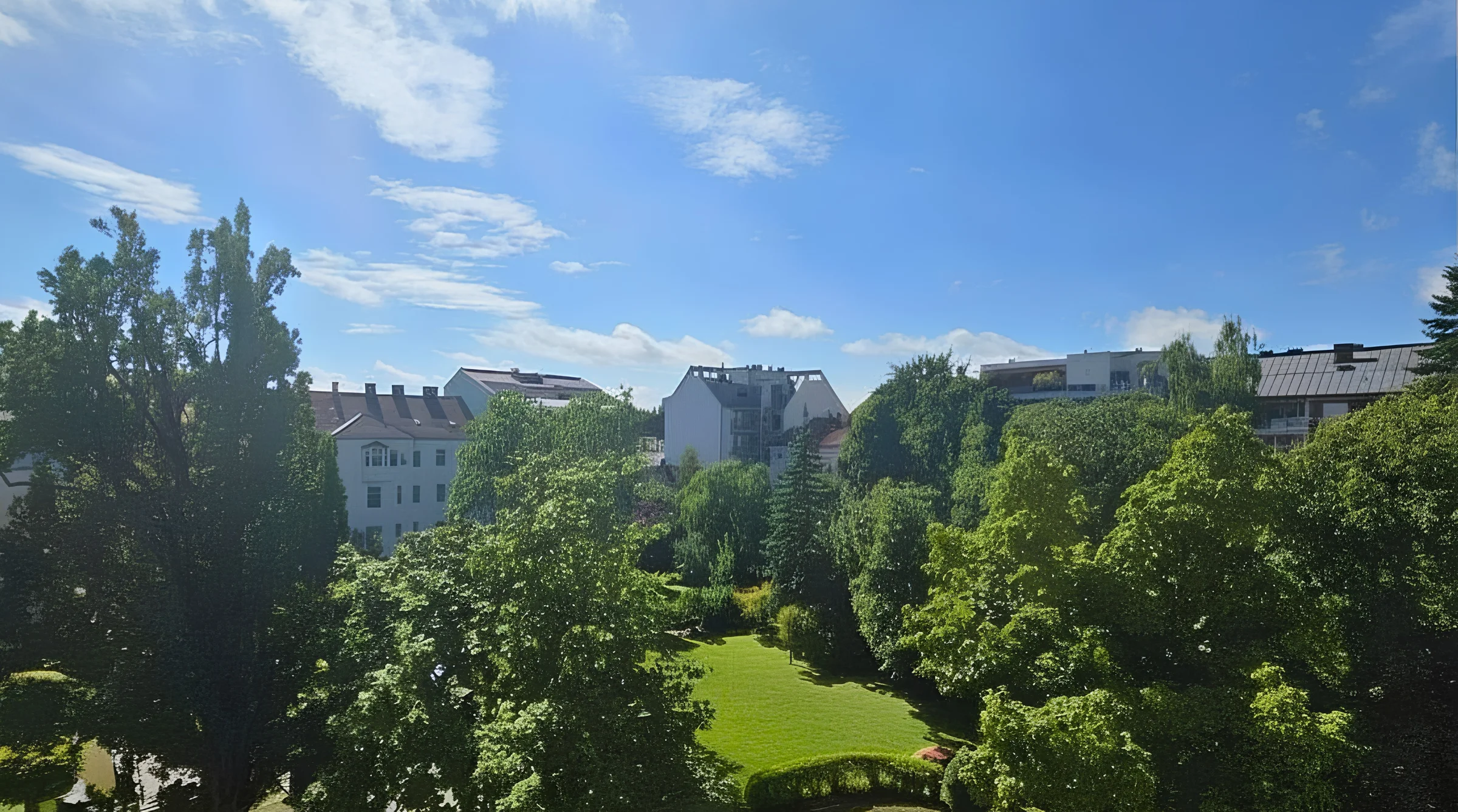 Blick vom Balkon in den grünen Innenhof – LIVIO, Linz